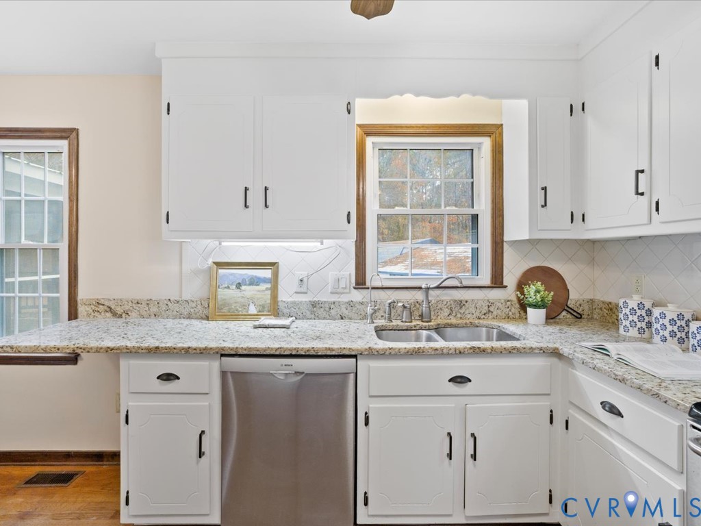 1145 Timber Trace Road Powhatan, VA 23139 - Photo 9 of 32 a kitchen with stainless steel appliances granite countertop a sink a stove and cabinets
