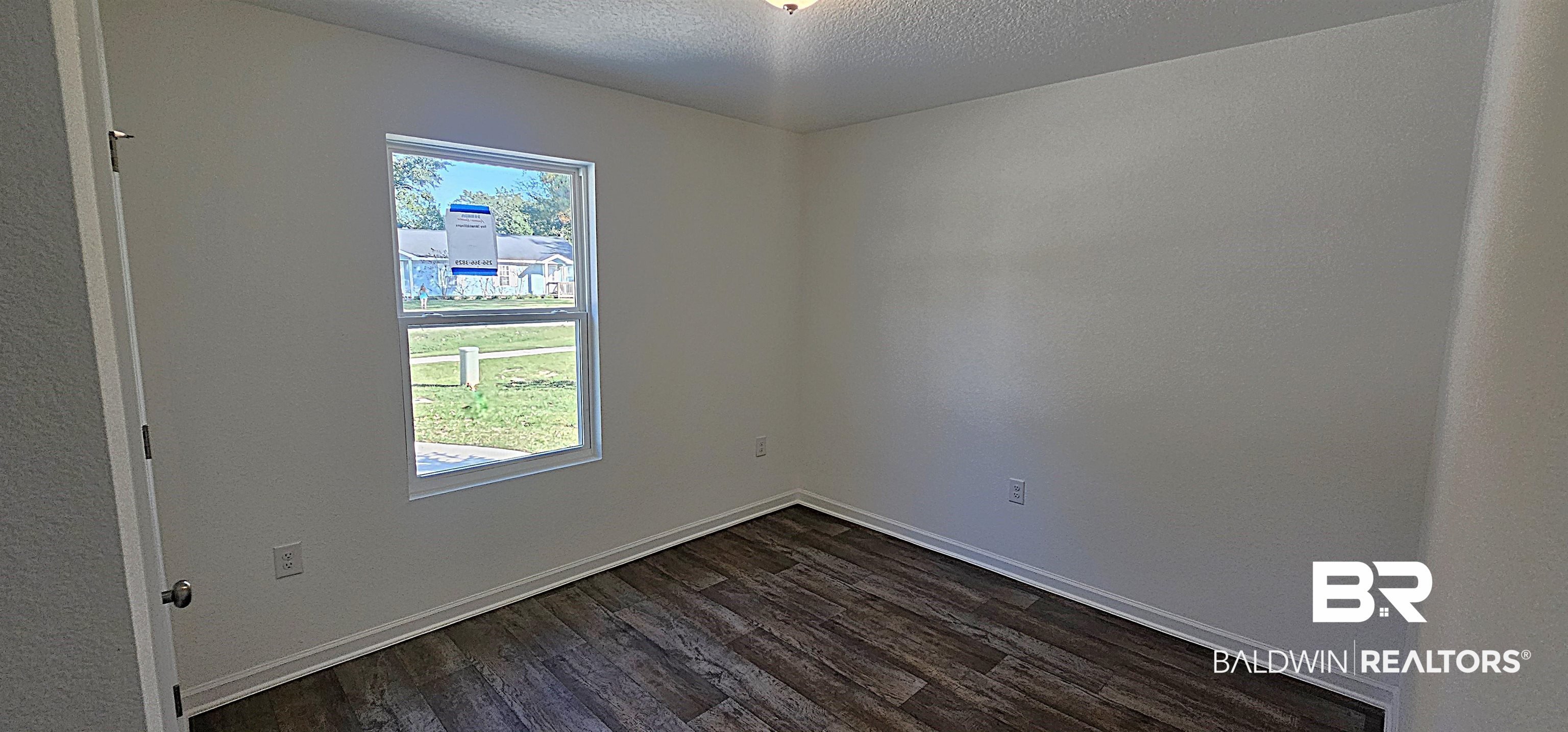 1148 Sweet Laurel Street Foley, AL 36535 - Photo 16 of 18 Empty room with dark hardwood / wood-style floors and a textured ceiling