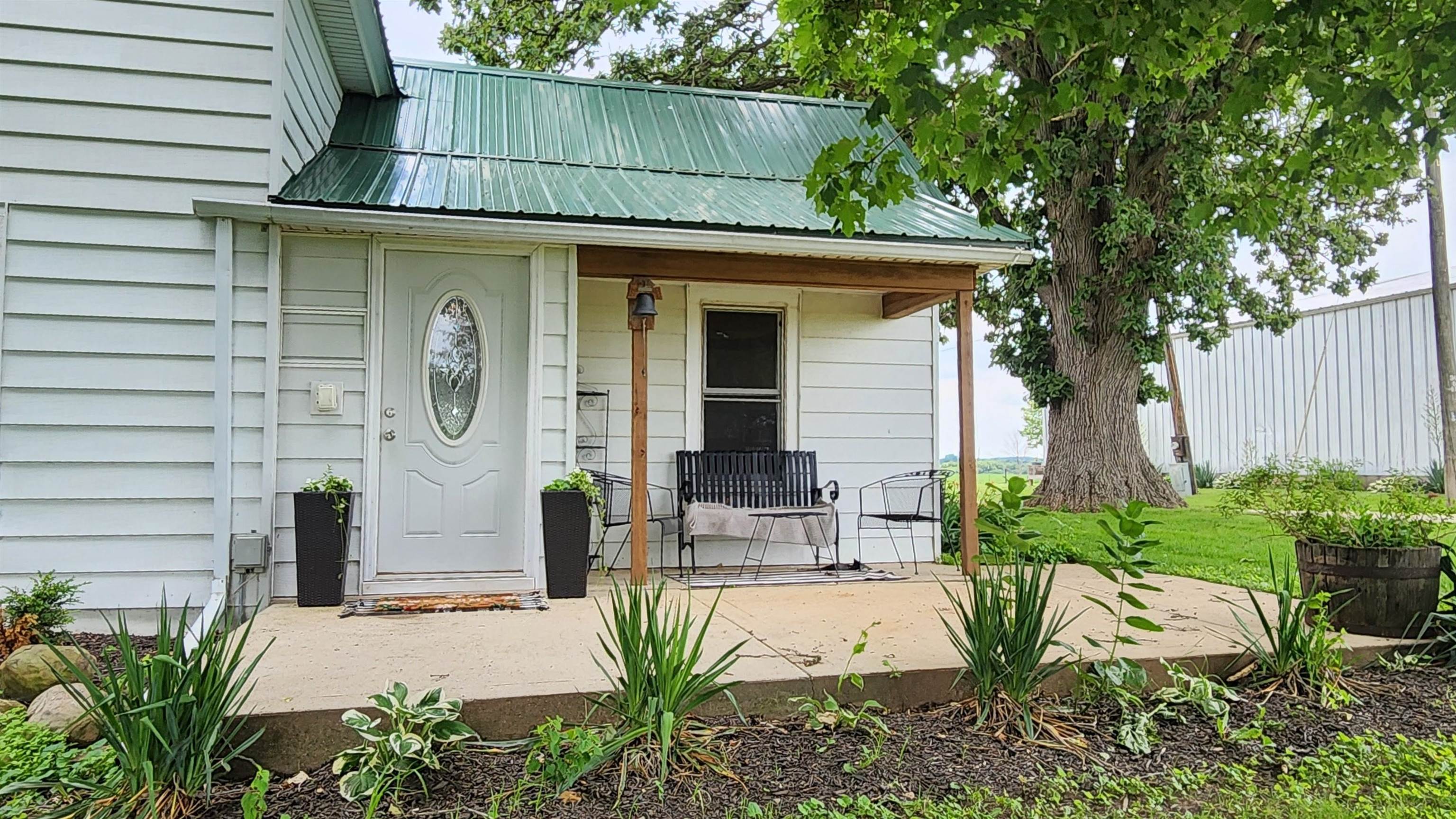 8999 Centerville Road Capron, IL 61012 - Photo 67 of 69 a front view of a house with garden