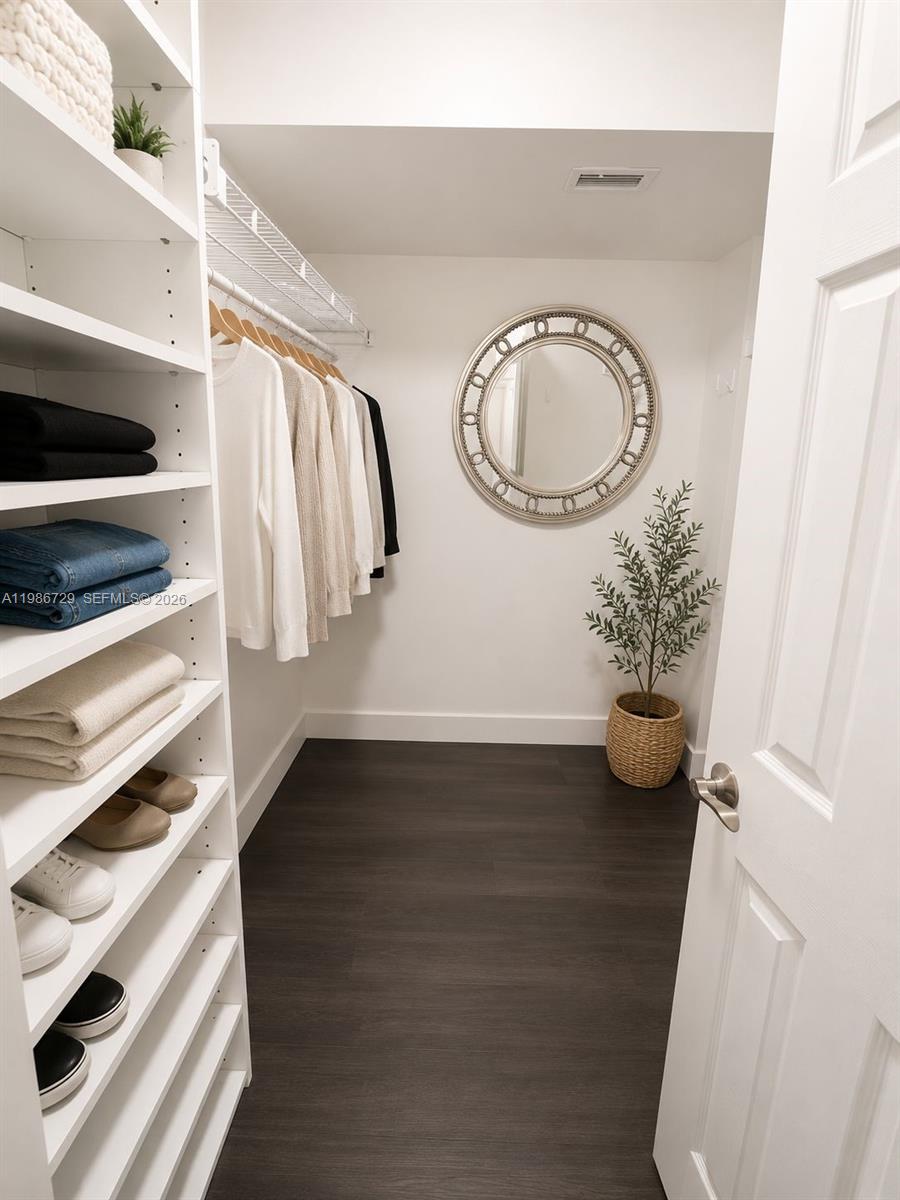299 Northwest 52nd Terrace, Unit PHX Boca Raton, FL 33487 - Photo 3 of 16 a view of walk in closet with clothes and shoes