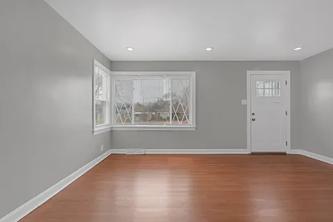 a view of wooden floor and windows in a room
