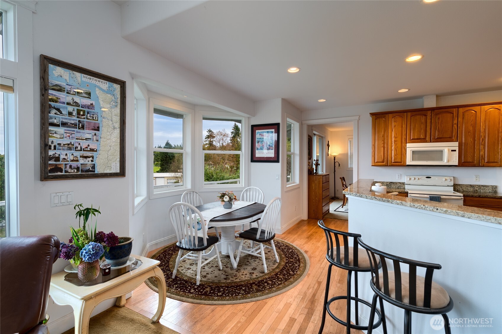 4111 R Avenue Anacortes, WA 98221 - Photo 11 of 37 a kitchen with sink refrigerator dining table and chairs