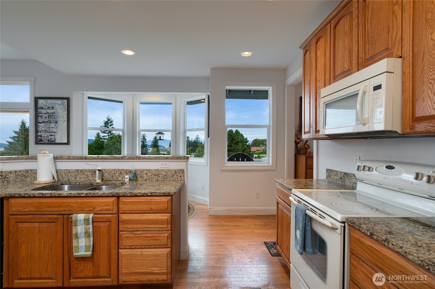 4111 R Avenue Anacortes, WA 98221 - Photo 13 of 37 a kitchen with stainless steel appliances granite countertop a stove a sink and a microwave