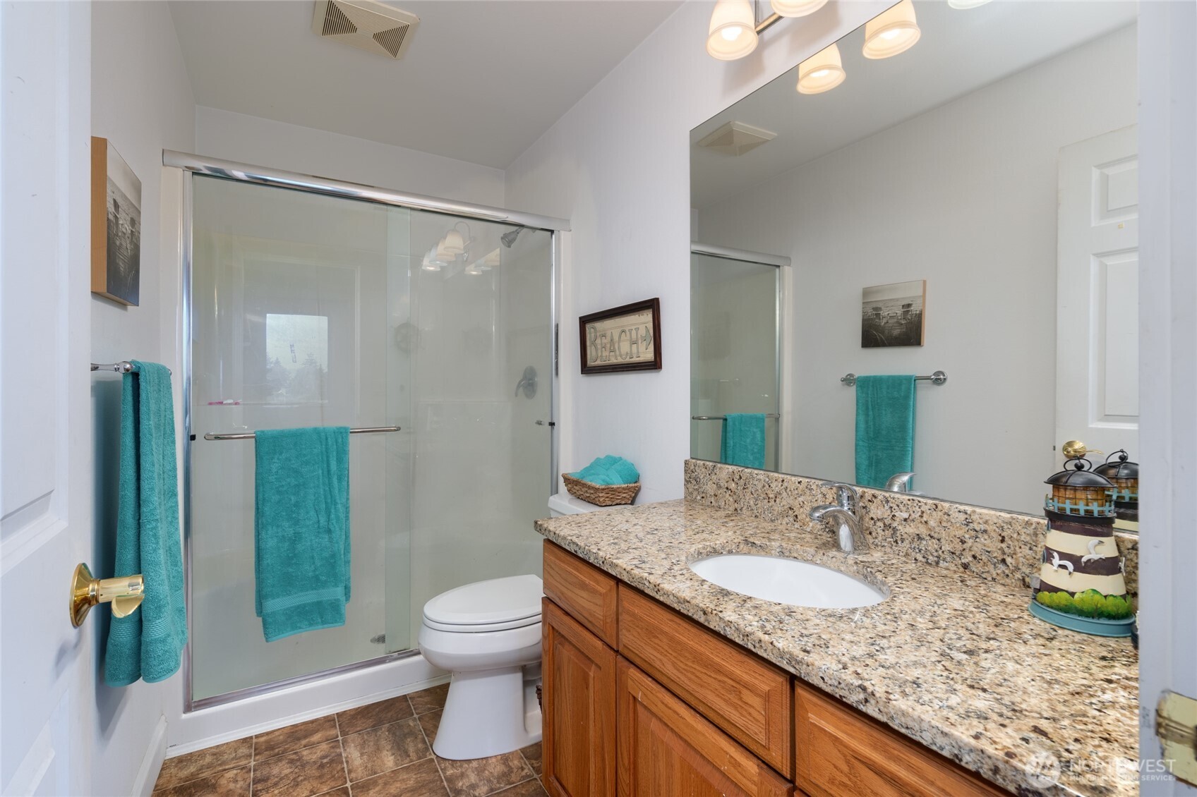 4111 R Avenue Anacortes, WA 98221 - Photo 32 of 37 a bathroom with a granite countertop sink toilet and shower