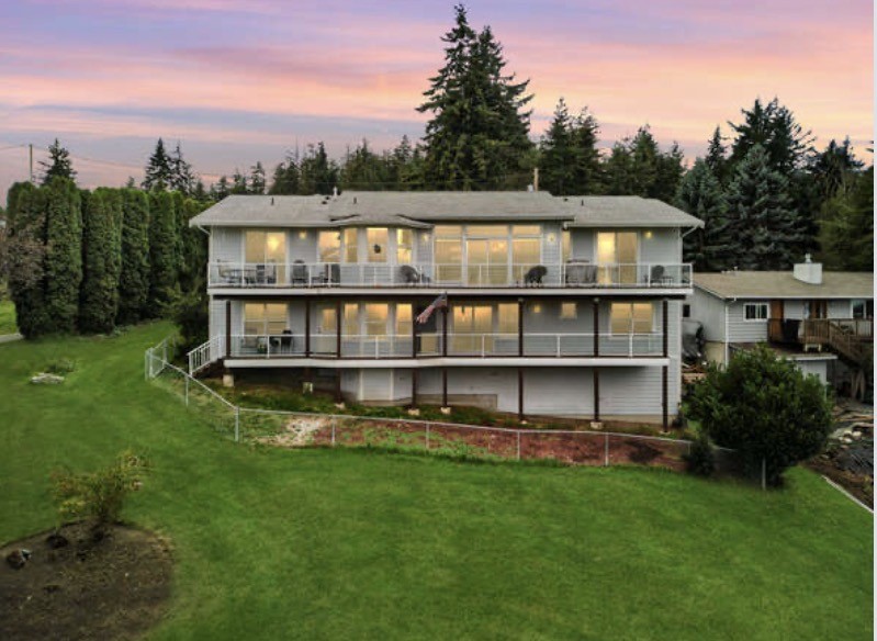 4111 R Avenue Anacortes, WA 98221 - Photo 5 of 37 a view of a house with a big yard and large trees