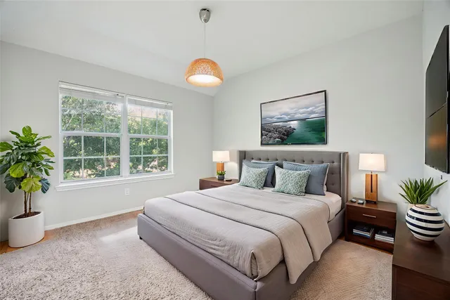 a bedroom with bed and a potted plant