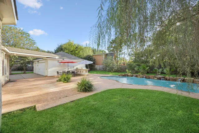 a front view of house with yard and trees