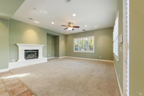 a view of an empty room with a fireplace