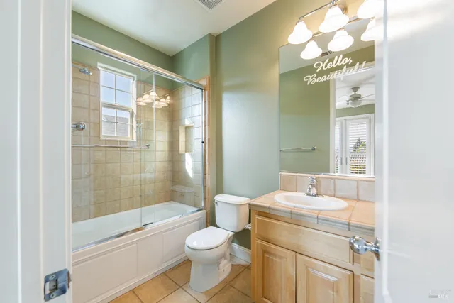 a bathroom with a bathtub shower sink vanity and toilet