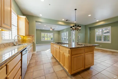 a large kitchen with stainless steel appliances granite countertop a sink and a stove