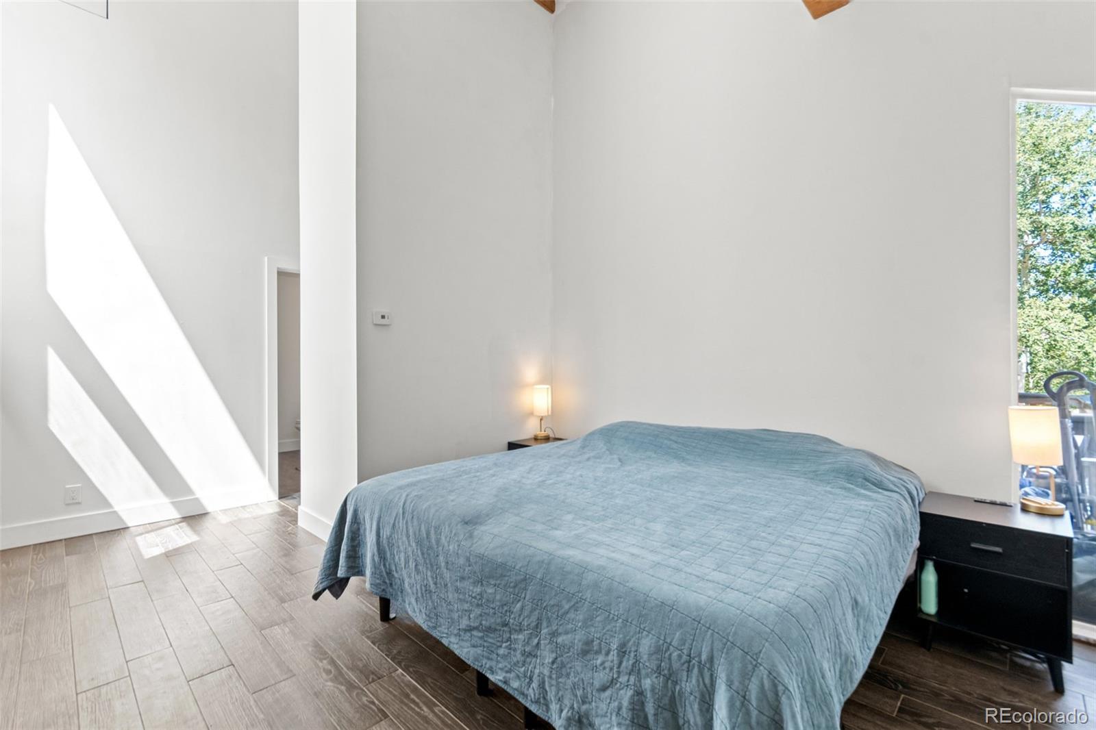 4316 Smith Hill Road Black Hawk, CO 80422 - Photo 12 of 48 a bedroom with a bed and wooden floor