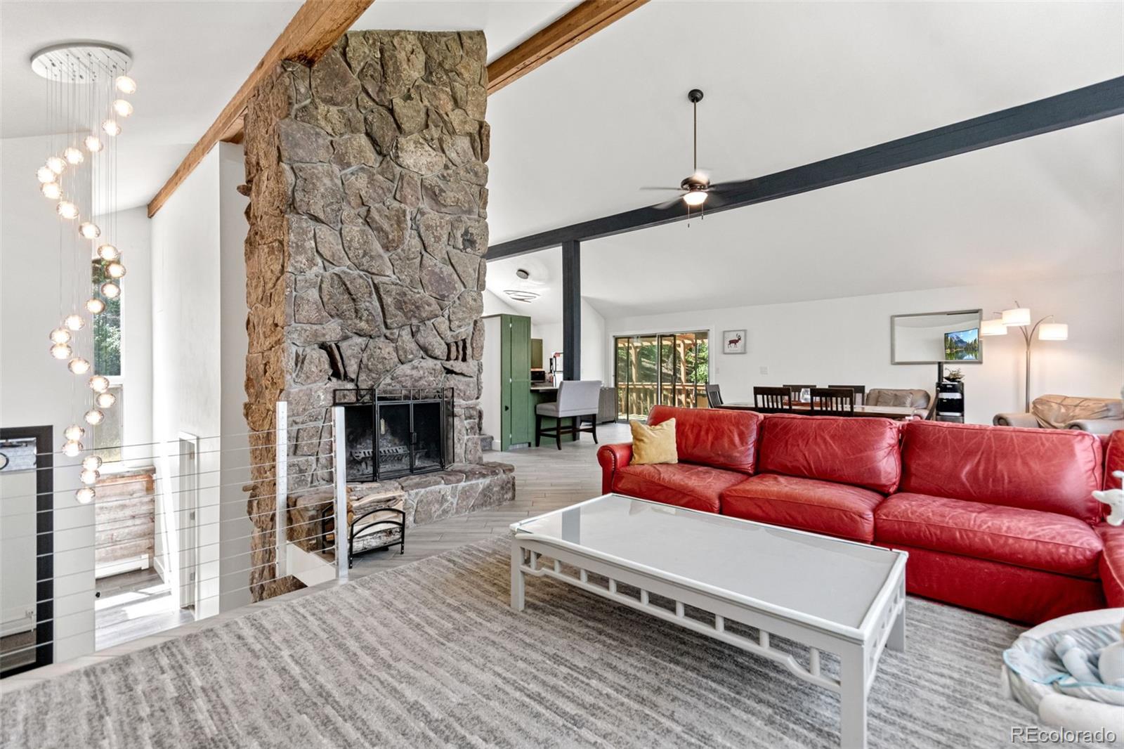 4316 Smith Hill Road Black Hawk, CO 80422 - Photo 17 of 48 a living room with furniture a fireplace and a chandelier