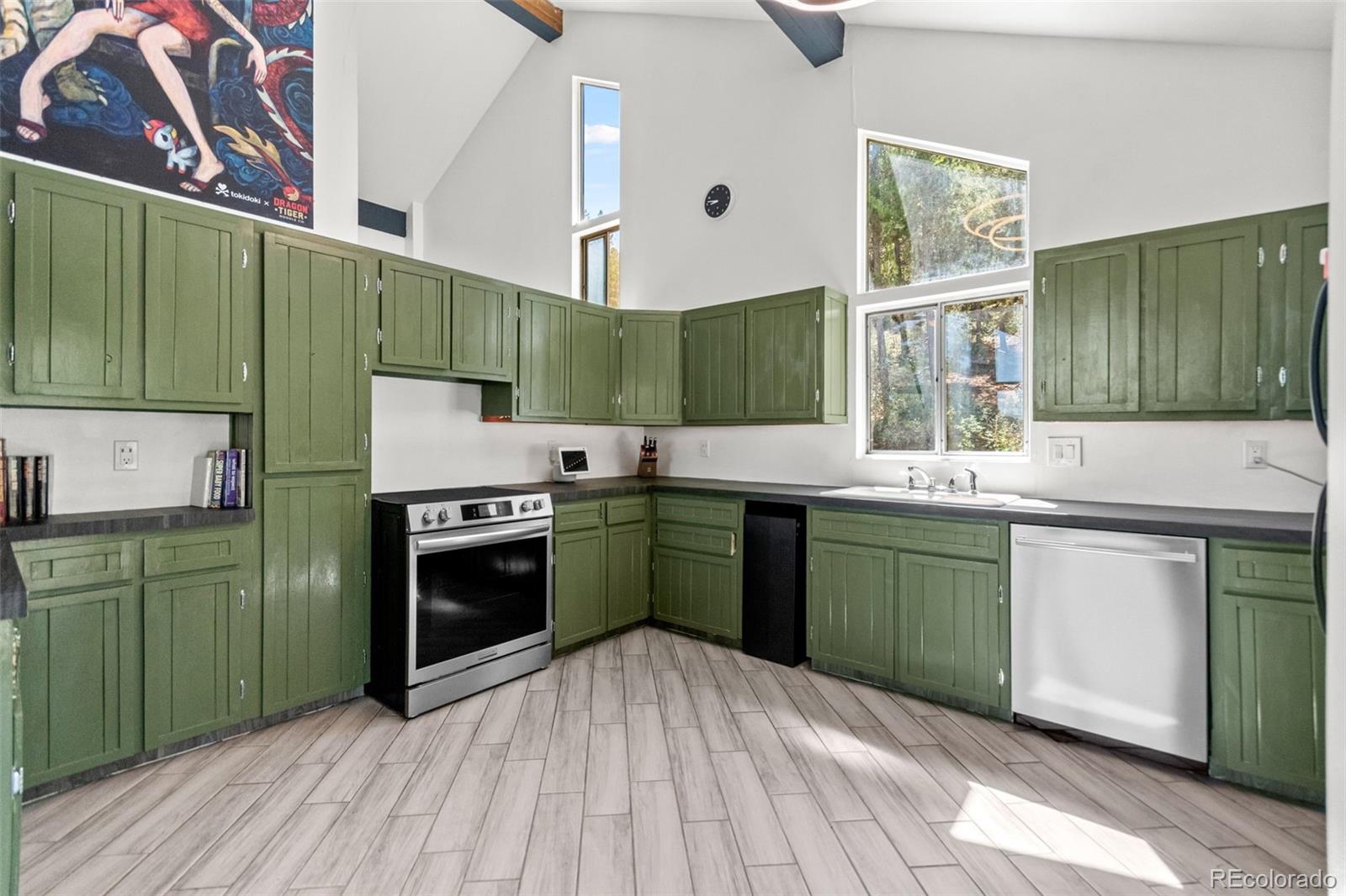 4316 Smith Hill Road Black Hawk, CO 80422 - Photo 24 of 48 a kitchen with a sink a stove and cabinets