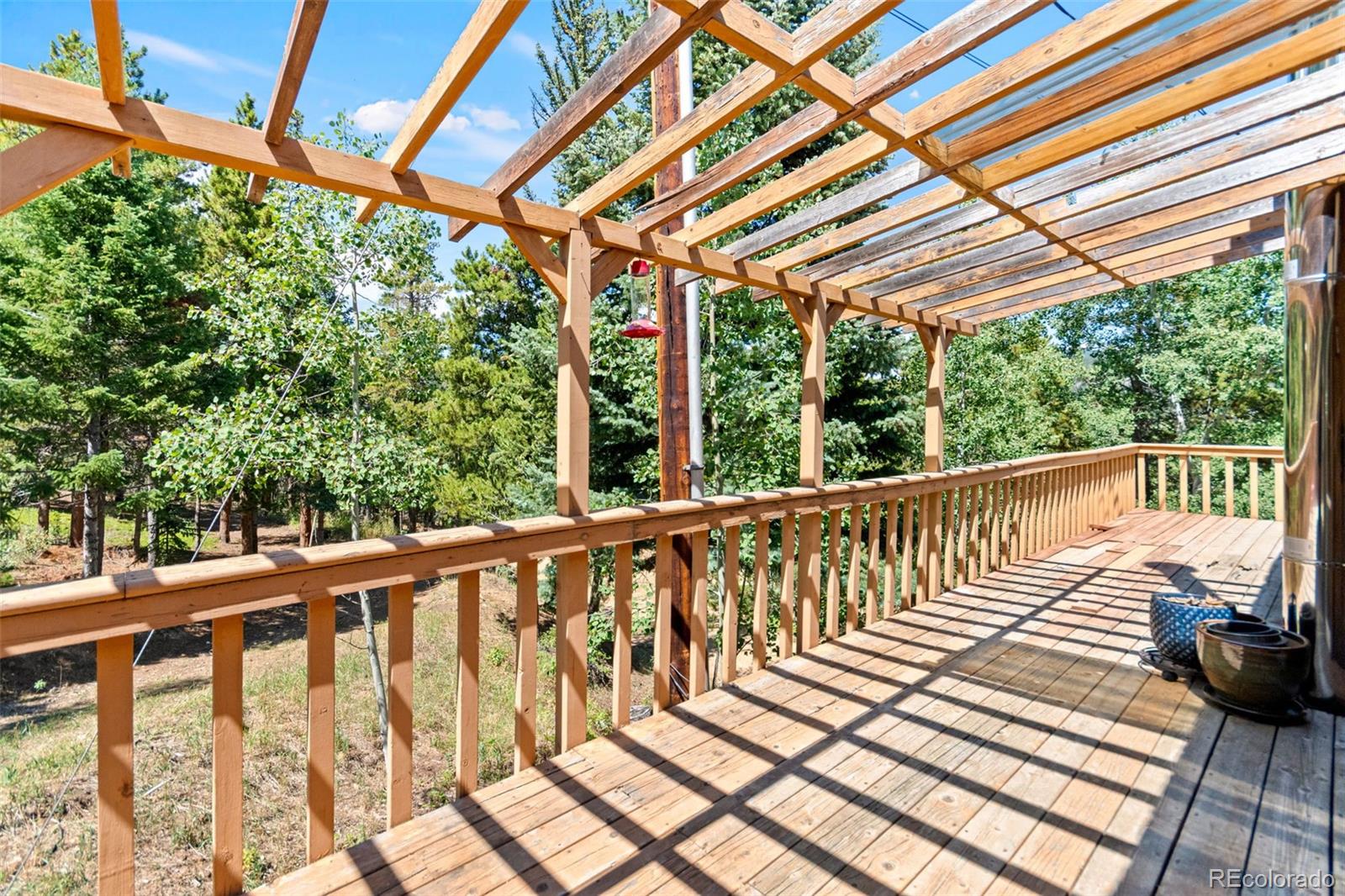 4316 Smith Hill Road Black Hawk, CO 80422 - Photo 27 of 48 a porch with wooden floor in outdoor space
