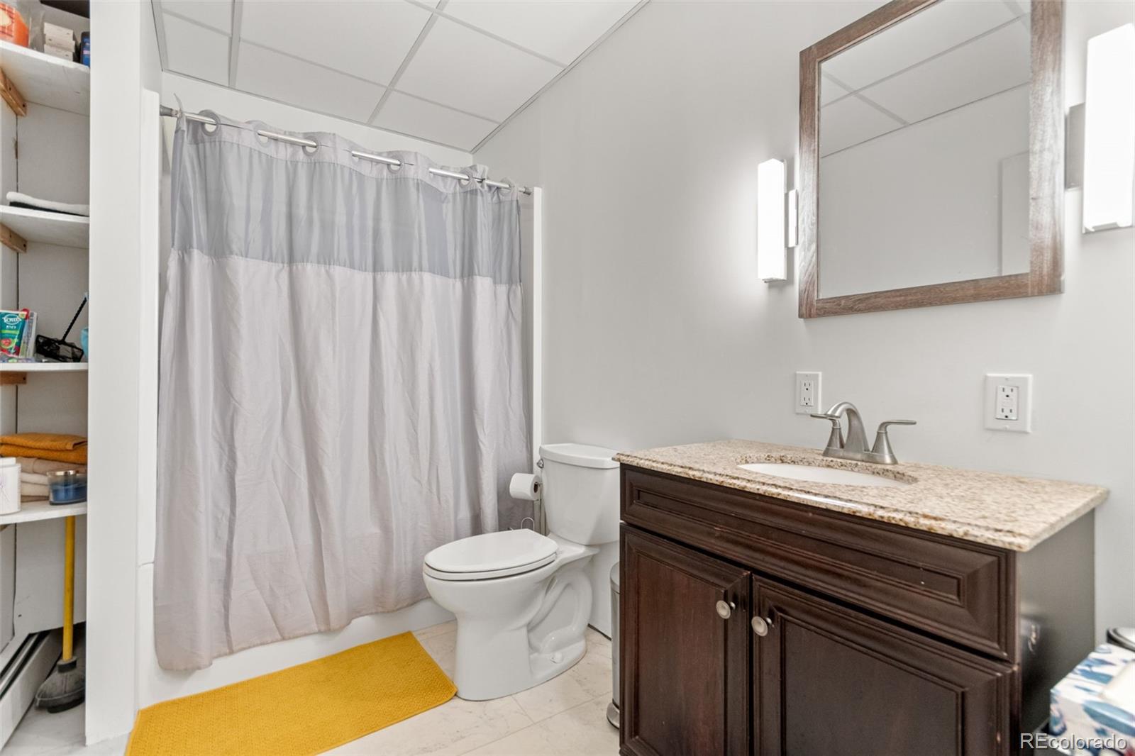 4316 Smith Hill Road Black Hawk, CO 80422 - Photo 36 of 48 a bathroom with a granite countertop sink toilet and a mirror