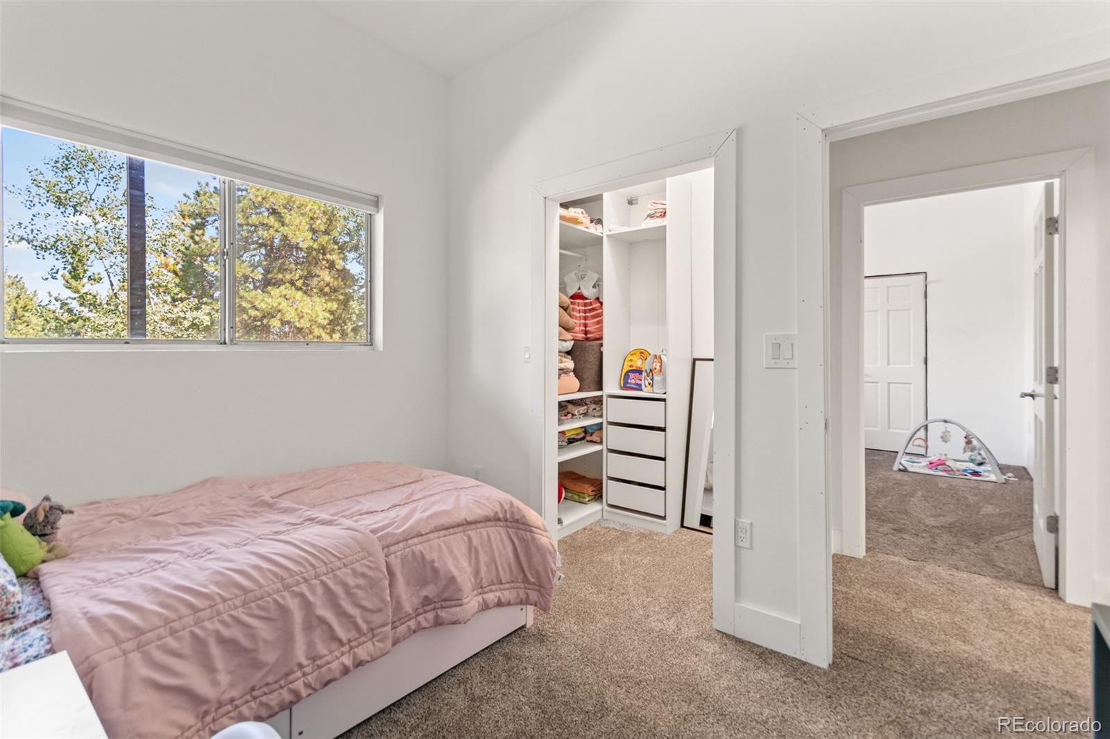 4316 Smith Hill Road Black Hawk, CO 80422 - Photo 38 of 48 a bedroom with a bed and a painting on the wall