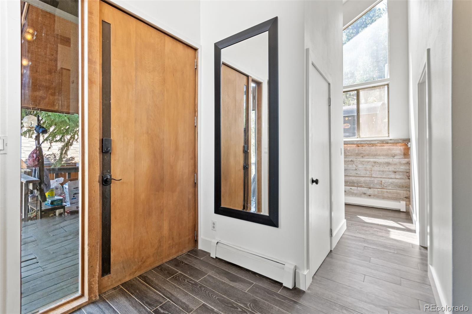 4316 Smith Hill Road Black Hawk, CO 80422 - Photo 6 of 48 a view of a hallway with wooden floor and windows