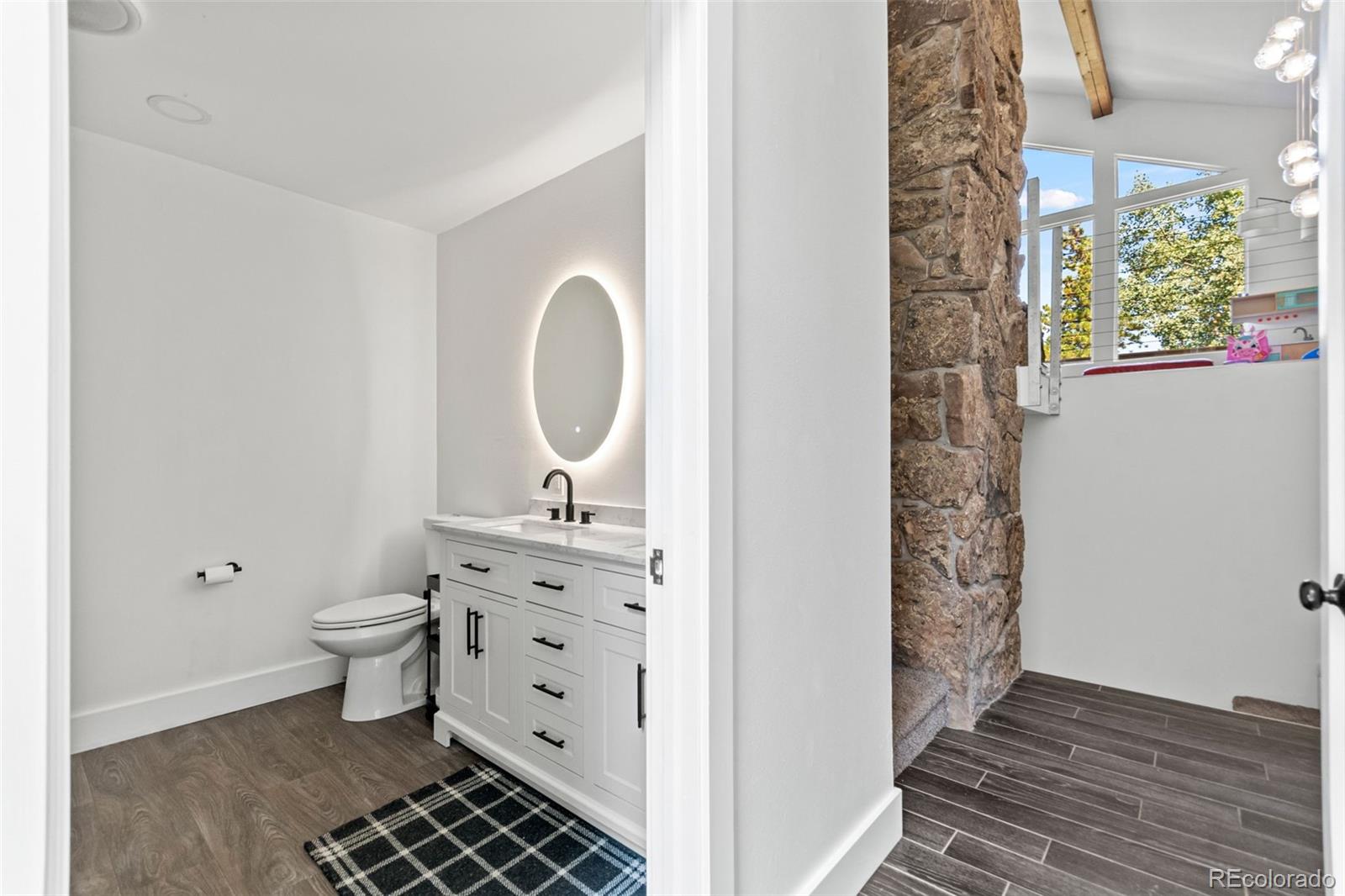 4316 Smith Hill Road Black Hawk, CO 80422 - Photo 7 of 48 a bathroom with a toilet a sink and a window