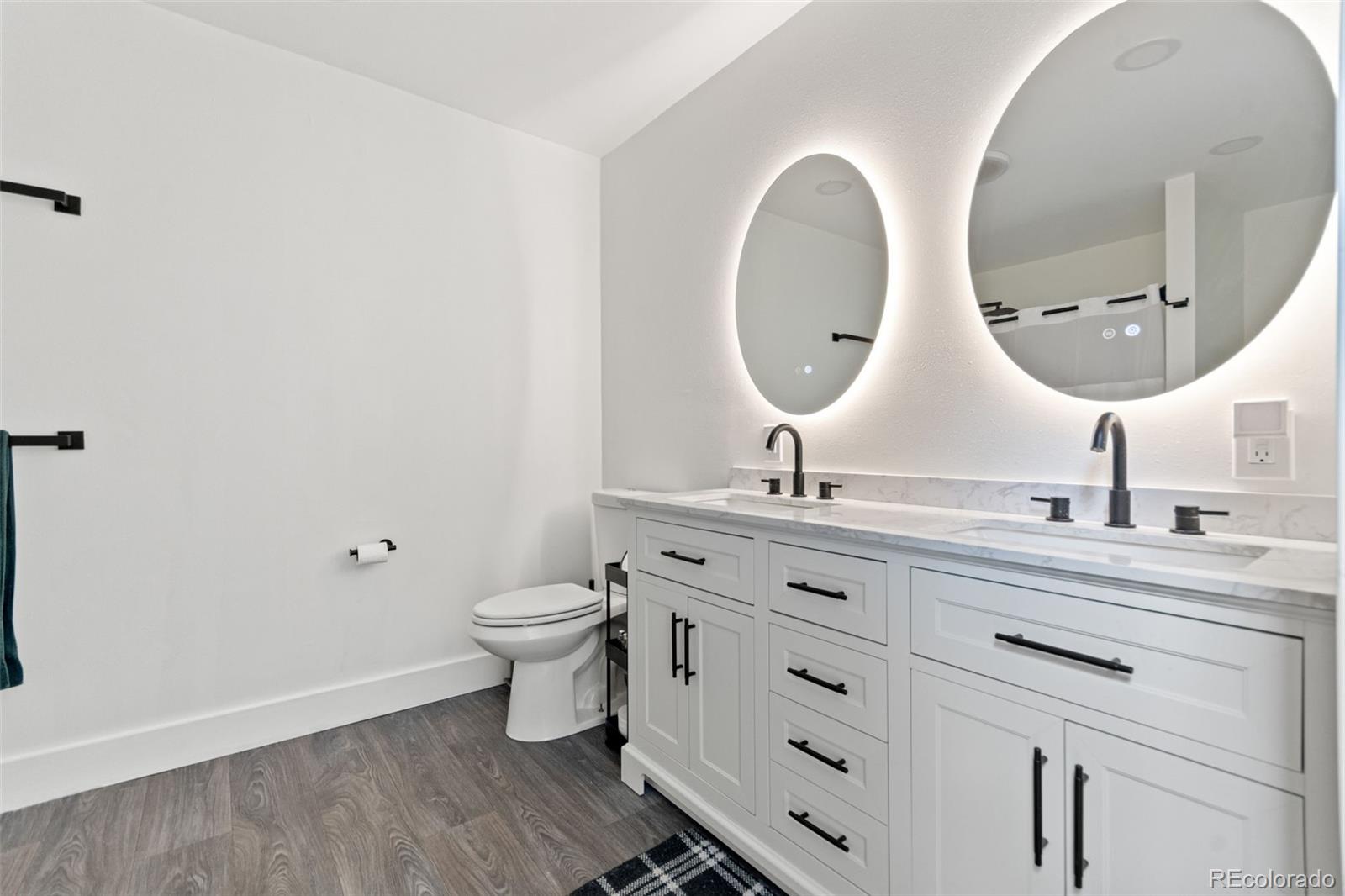 4316 Smith Hill Road Black Hawk, CO 80422 - Photo 8 of 48 a bathroom with a double vanity sink and a mirror