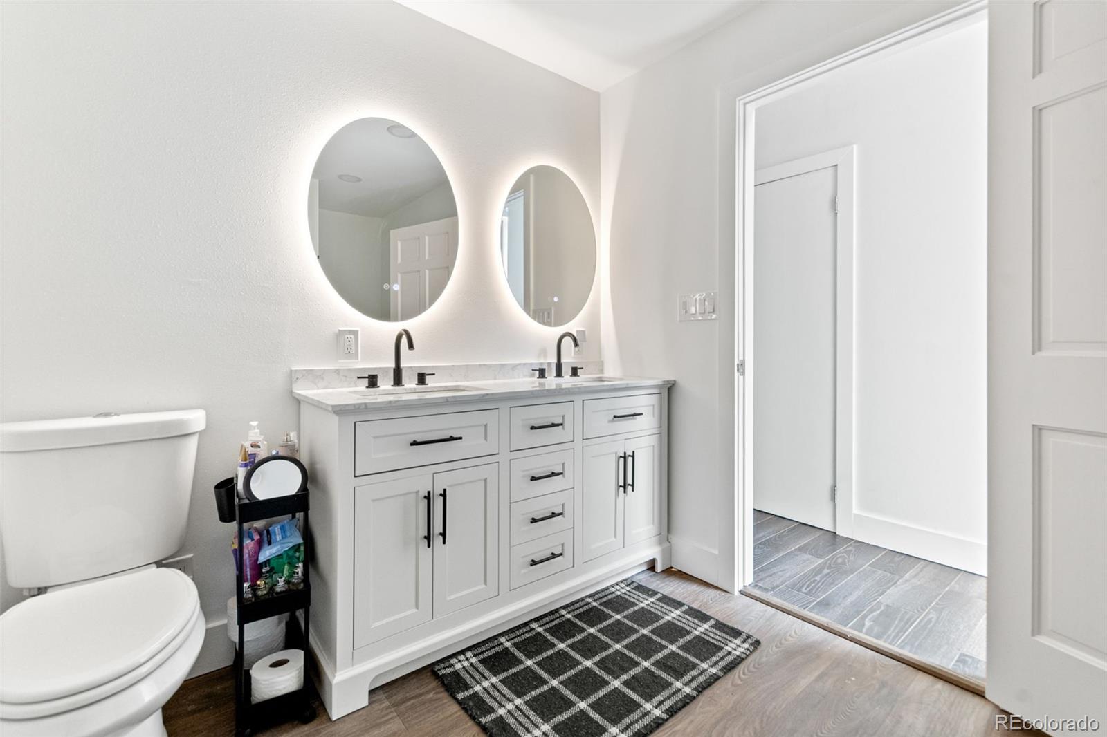 4316 Smith Hill Road Black Hawk, CO 80422 - Photo 9 of 48 a bathroom with a toilet a sink and a mirror