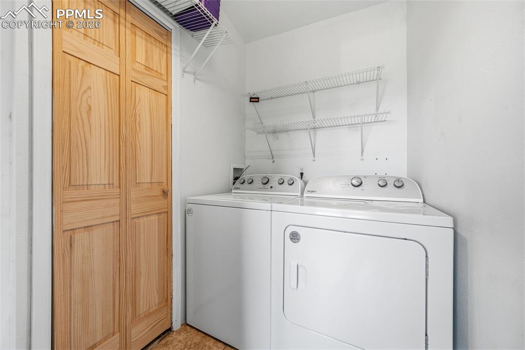 5535 Peerless Farms Road Peyton, CO 80831 - Photo 12 of 27 a utility room with dryer and washer
