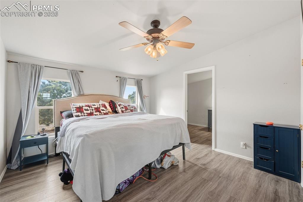 5535 Peerless Farms Road Peyton, CO 80831 - Photo 13 of 27 a bedroom with a bed and a dresser