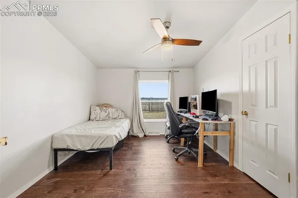 a bedroom with a bed and a desk