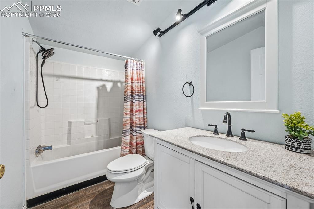 5535 Peerless Farms Road Peyton, CO 80831 - Photo 19 of 27 a bathroom with a granite countertop sink toilet and shower