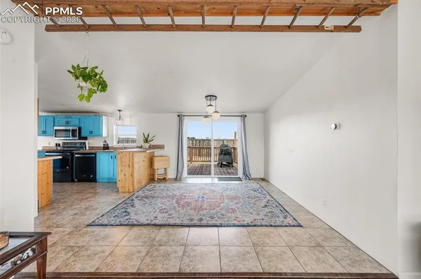 a view of kitchen with microwave a stove and cabinets