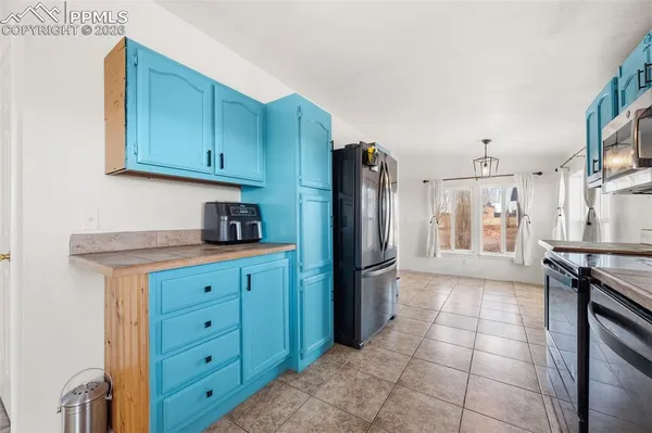 a kitchen with a refrigerator and cabinets