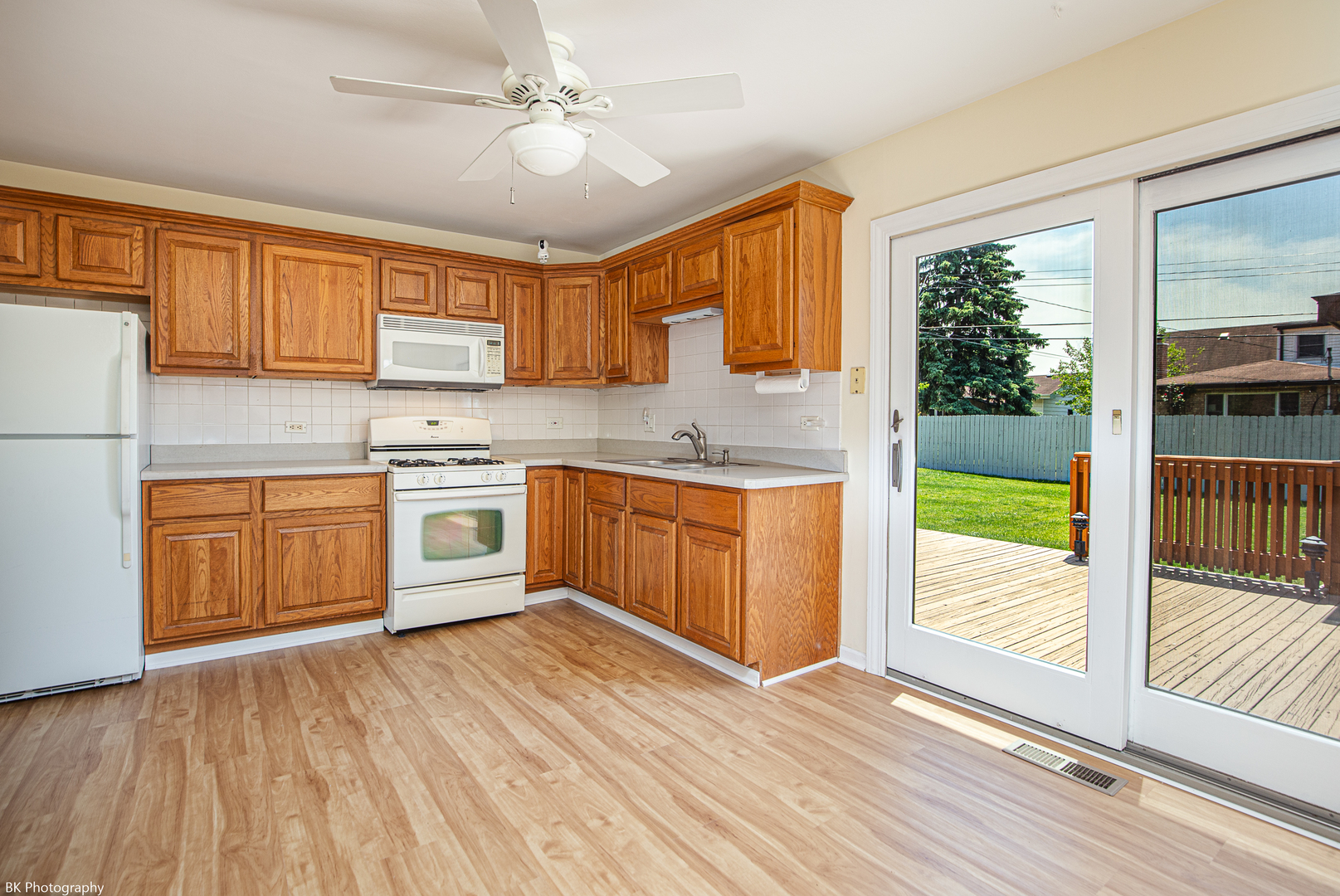 7049 West 91st Street Bridgeview, IL 60455 - Photo 5 of 25 a kitchen with stainless steel appliances granite countertop a stove a sink and a refrigerator with wooden floors