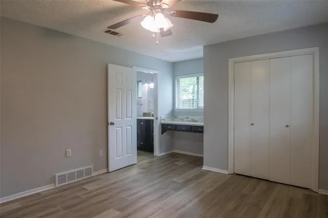 a view of an empty room and window and wooden floor
