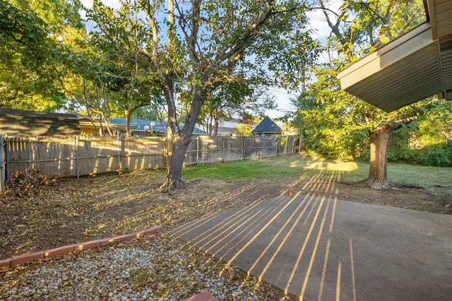 a front view of a house with a tree