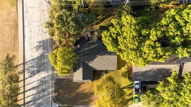 a front view of a house with a garden and yard