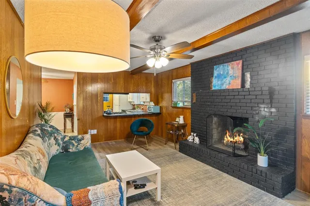 a living room with furniture a fireplace and a table