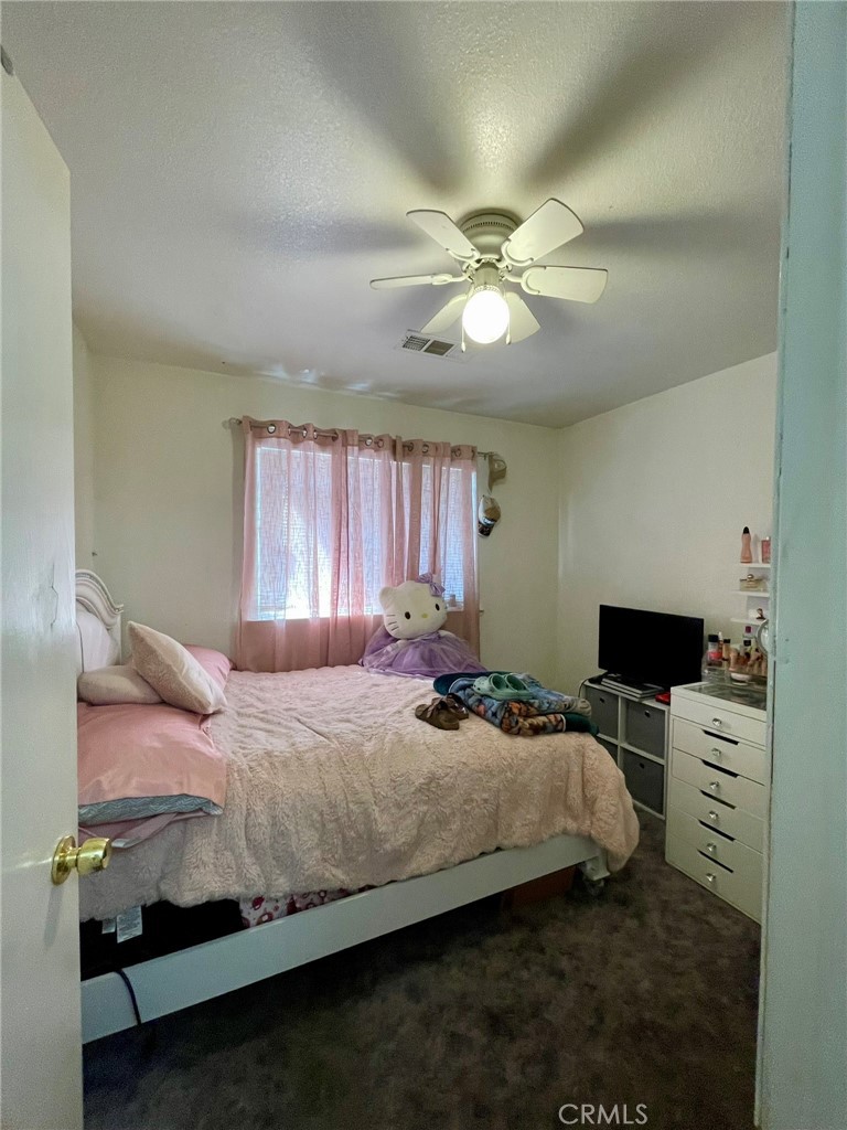 9654 Timothy Court Delhi, CA 95315 - Photo 13 of 18 a bedroom with a bed furniture and a flat screen tv