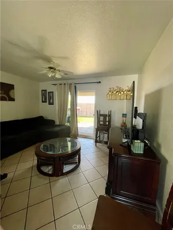a living room with furniture a flat screen tv and rug
