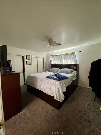 a bedroom with a bed and mirror
