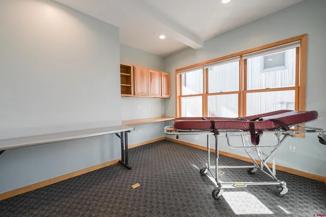 a view of a room with gym equipment and a window