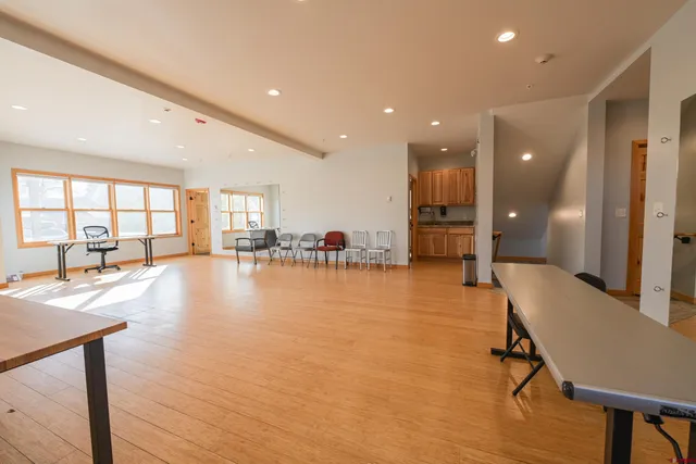 a room with lots of furniture and a large window