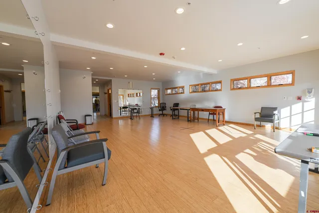a lobby with furniture and a flat screen tv