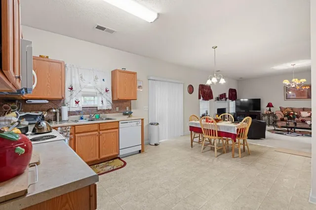 a kitchen filled with a white cabinets and chairs