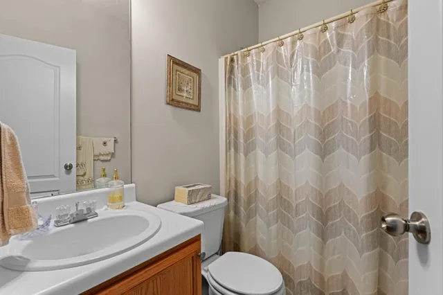 a bathroom with a sink toilet and a mirror