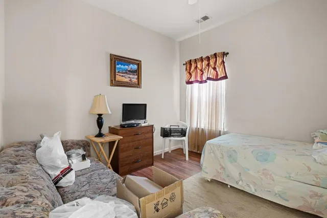 a bedroom with a bed and a couch