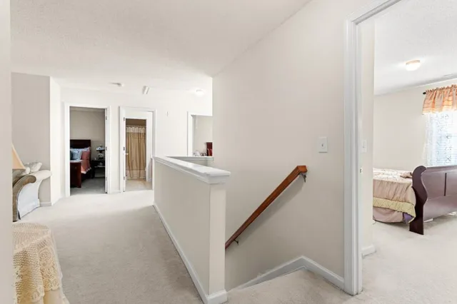 a view of a hallway with furniture and a livingroom view