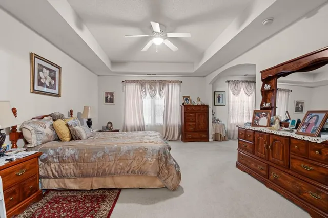 a bedroom with a bed furniture and a chandelier