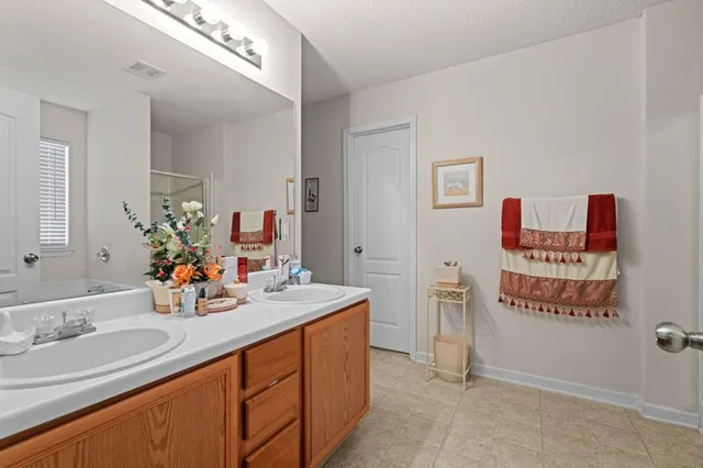 a bathroom with a sink double vanity and a mirror