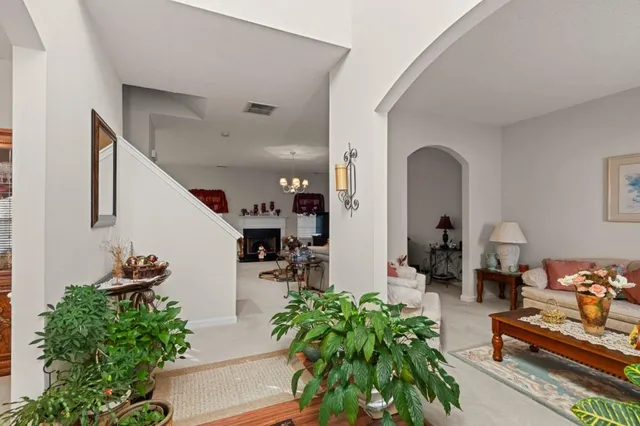 a lobby with furniture and potted plants