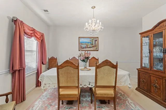 a view of a dining room with furniture and chandelier