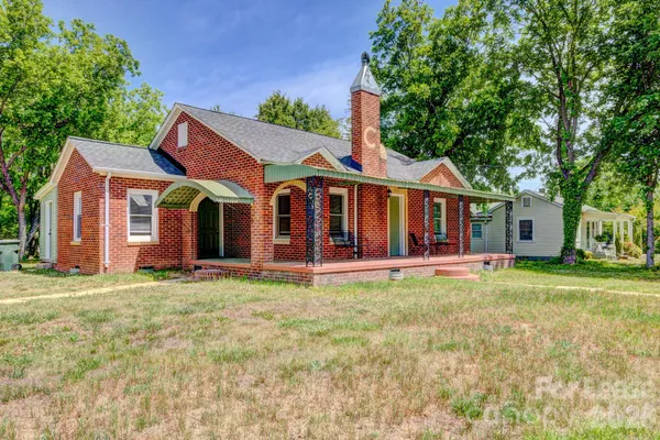 a front view of a house with a garden and porch